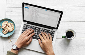 aerial-view-man-using-computer-laptop-wooden-table.jpg