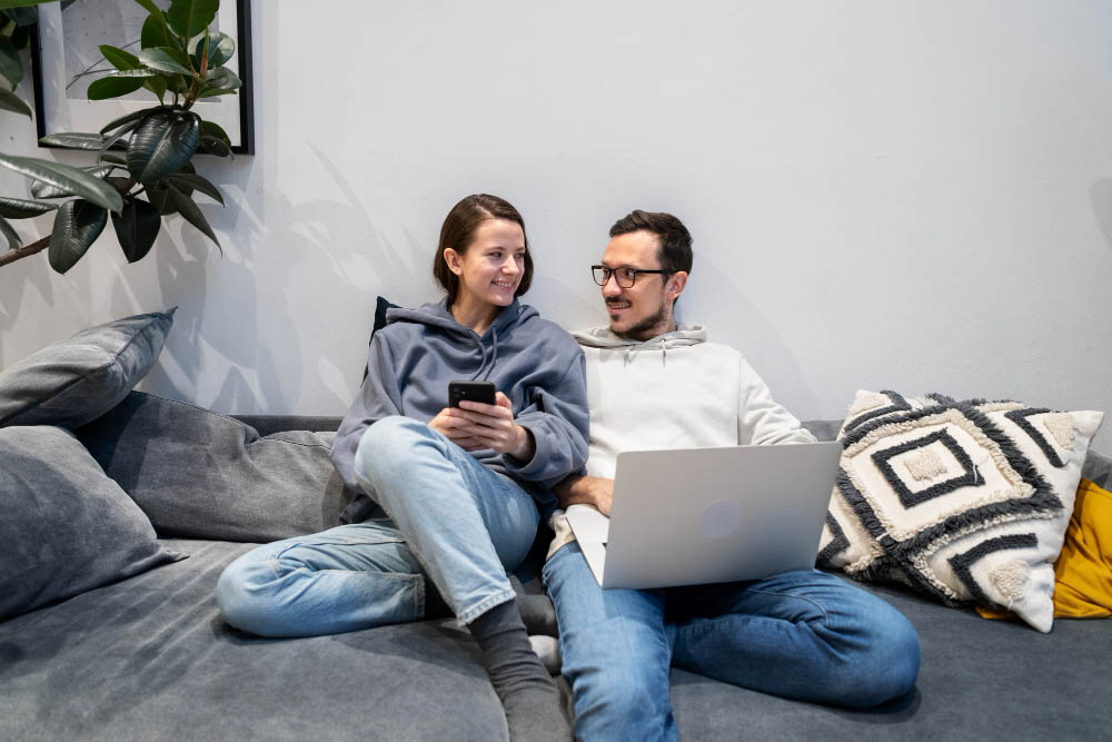 couple-working-from-home-together-sofa.jpg